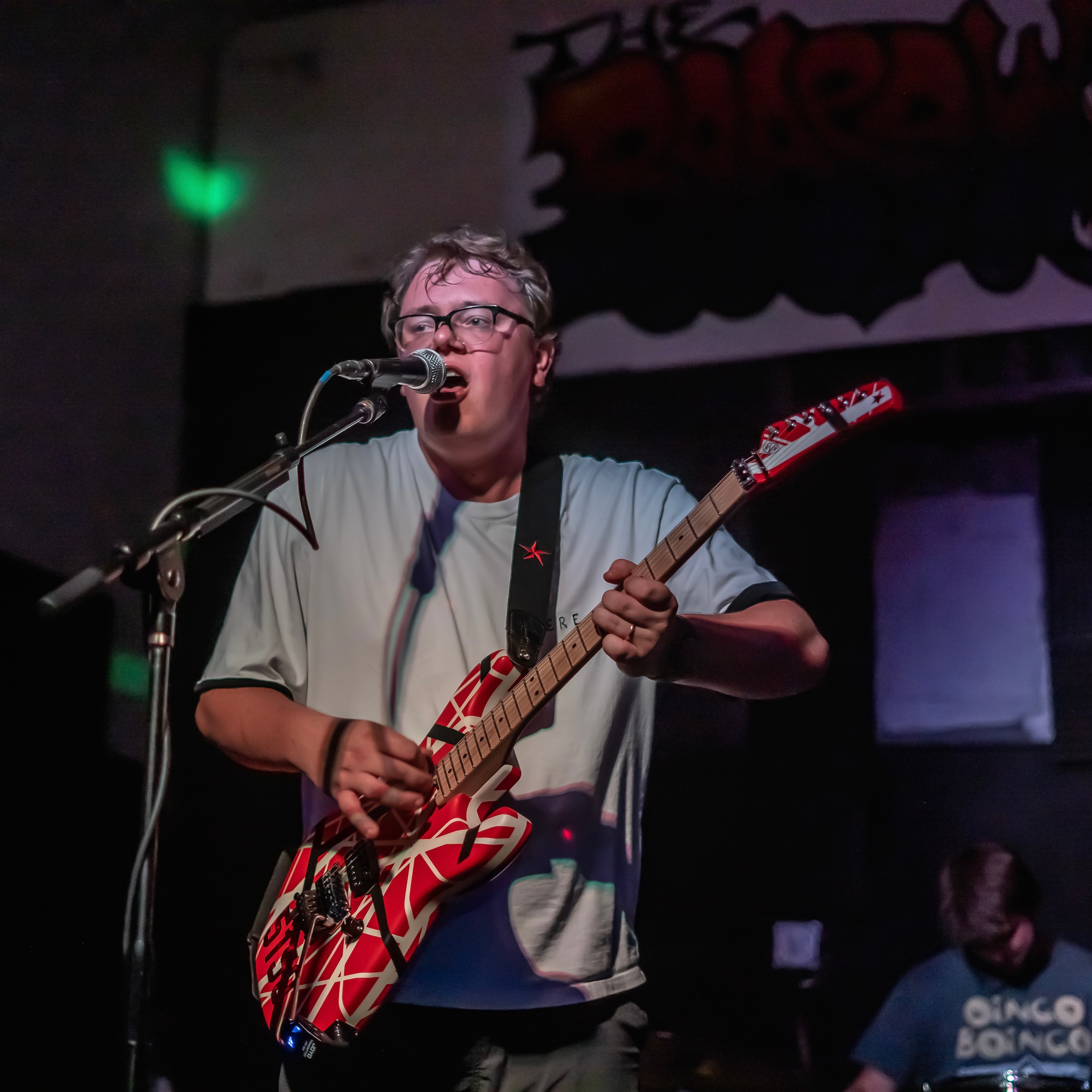 Jack Ryan Wright performing live on stage with red guitar