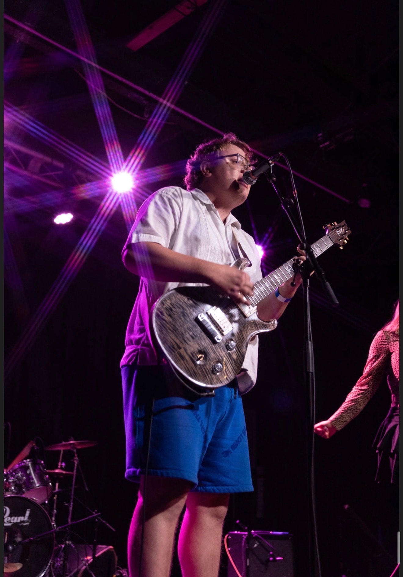 Jack Ryan Wright on stage under purple stage lighting